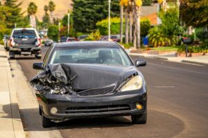 Passenger car with front-end damage after road accident.