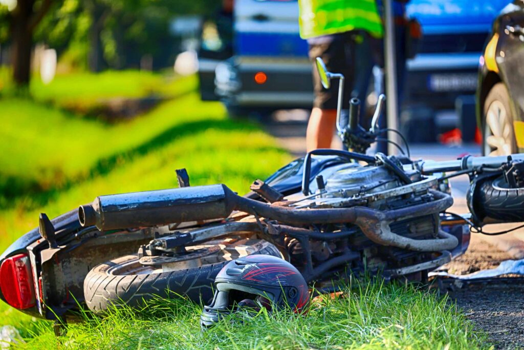 Motorcycle crash scene showing a wrecked bike and helmet, illustrating common types of deadly motorcycle accidents in Bakersfield