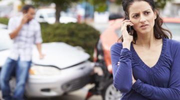 a woman calls a personal injury lawyer after a crash | The Law Offices of Mickey Fine