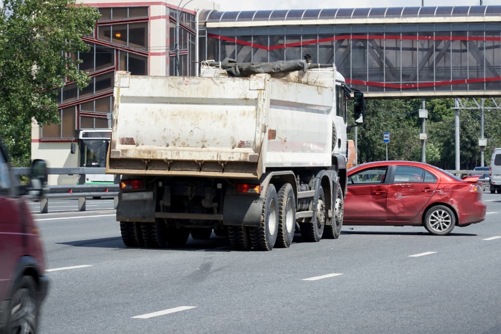 The collision of a truck and a car on a road intersection