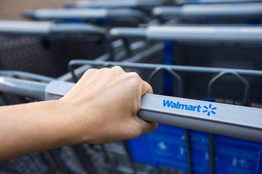 Customer pushing a Walmart shopping cart in Bakersfield, where slip and fall injuries may occur due to unsafe conditions.