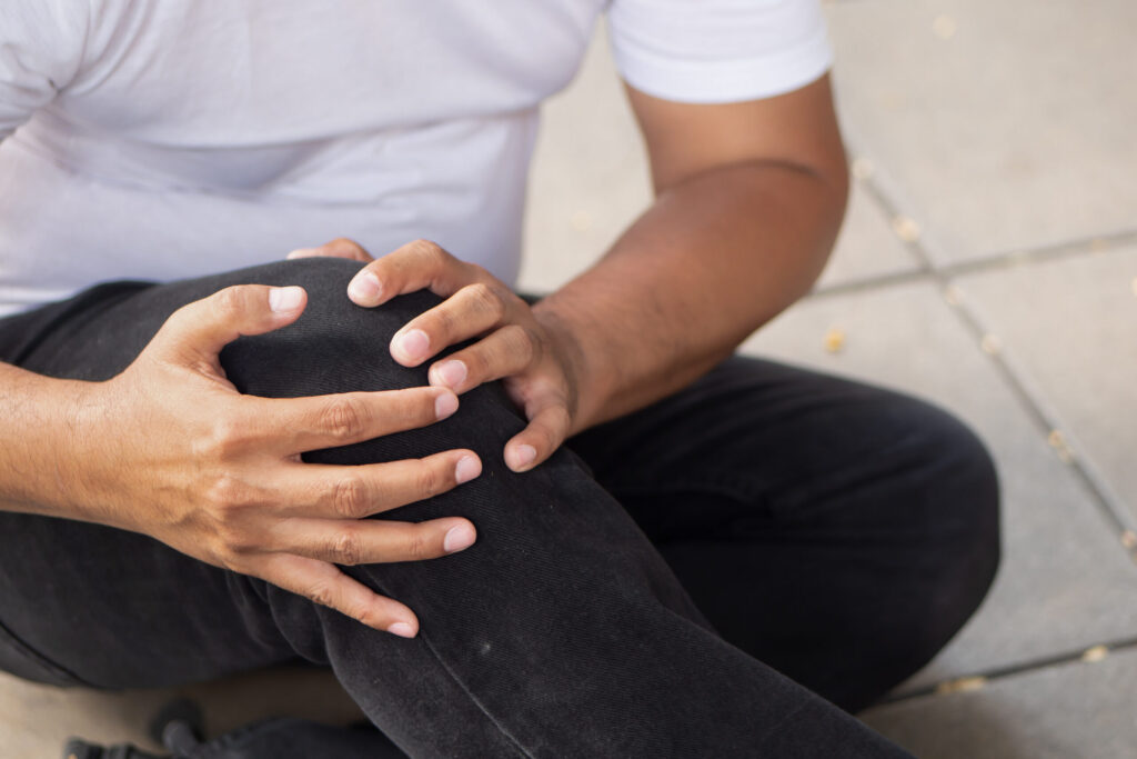 Injured shopper holding knee after a slip and fall accident at Walmart in Bakersfield, California.