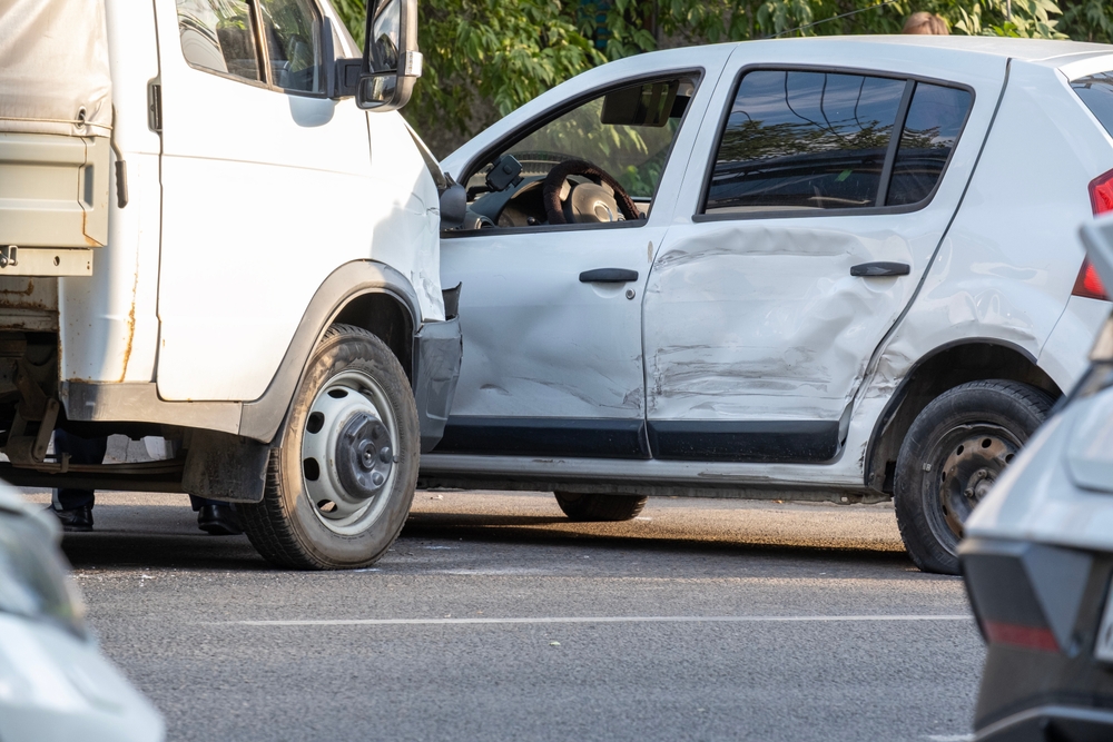 Passenger car severely damaged after a collision with a commercial truck in Bakersfield