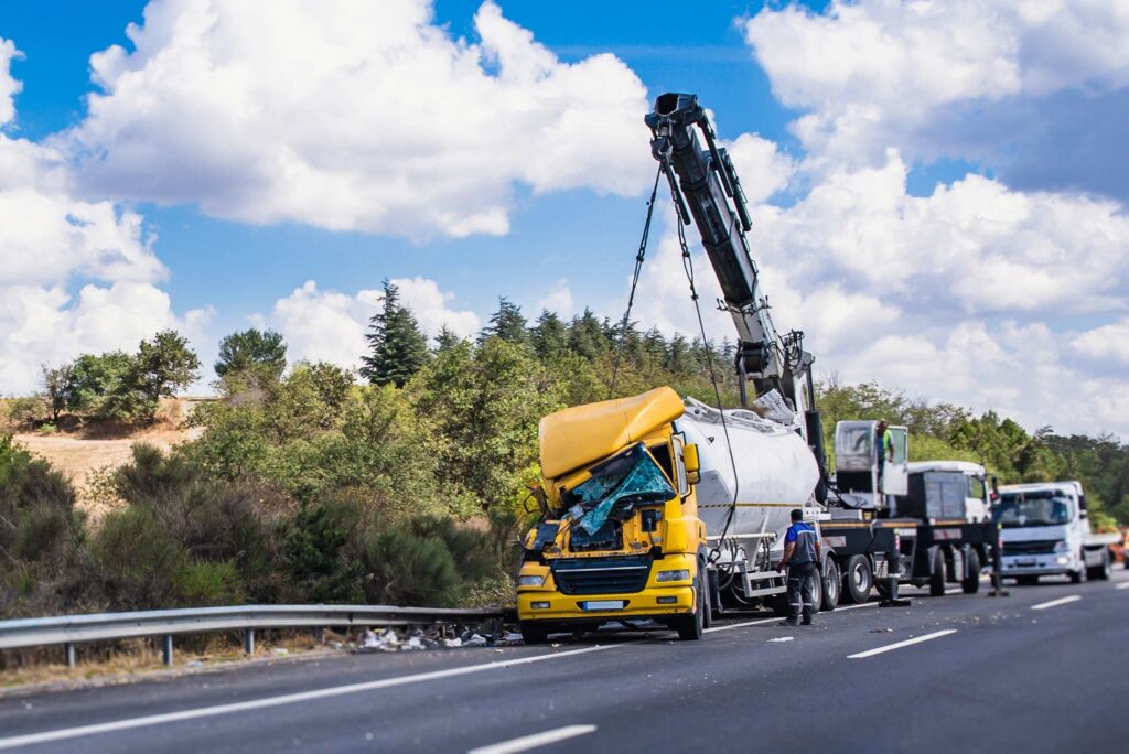 Cargo spill accident involving construction materials falling from a flatbed truck in Bakersfield, creating road hazards and legal liability concerns.