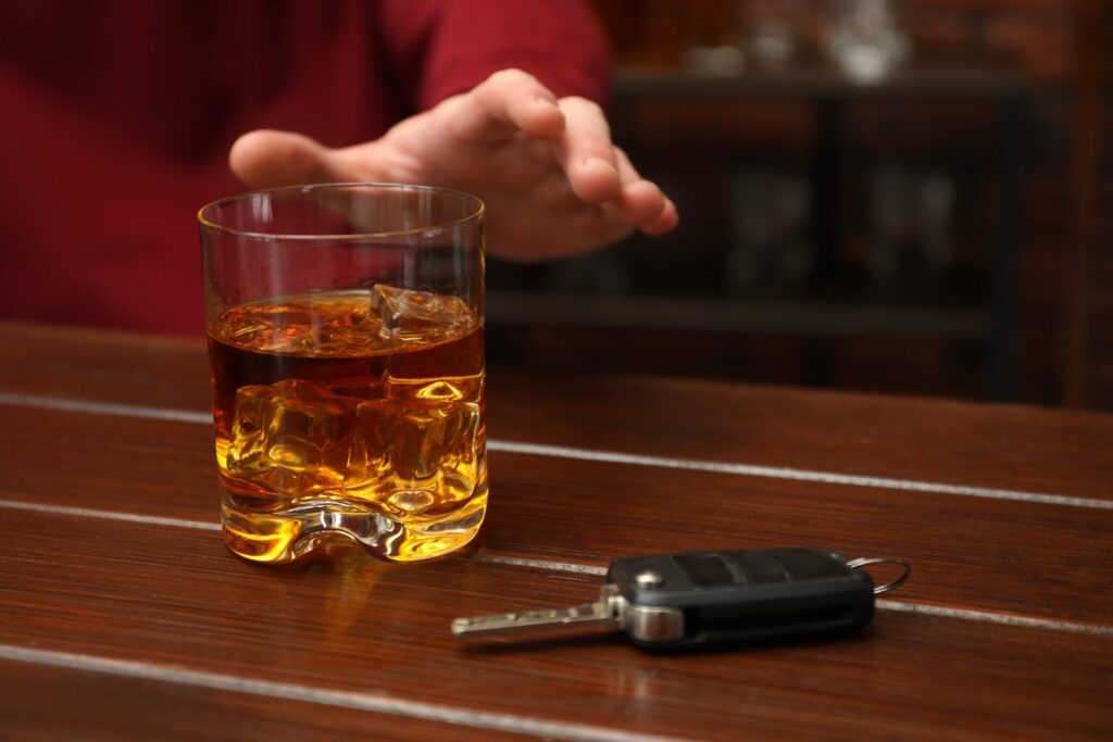 A patron being served alcohol in a bar, representing the narrow exception for suing the bar that overserved the drunk driver if they are a minor.