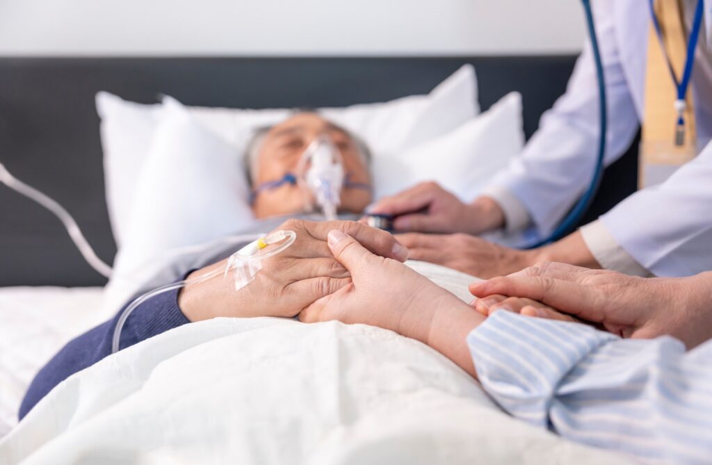 A grieving family member providing comfort in a hospital, illustrating the intangible losses considered when calculating the value of a life in a Bakersfield wrongful death case.