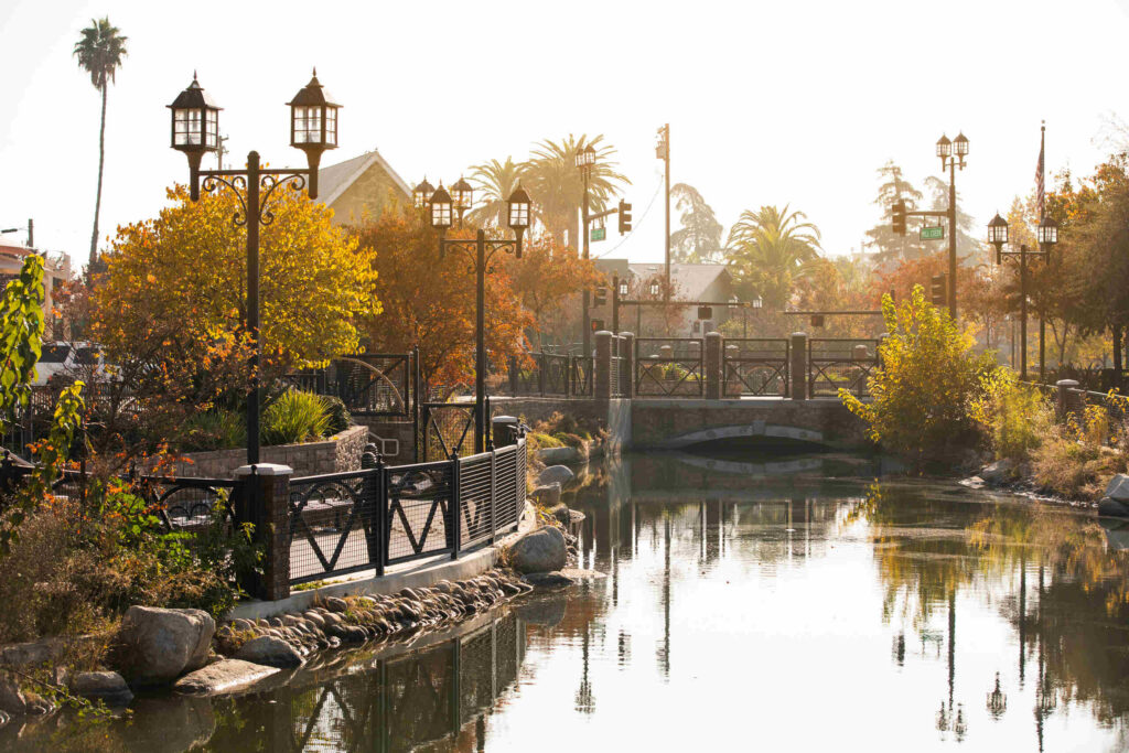A scenic canal park with bridges and palm trees in Bakersfield, California, showing the local service area for Bakersfield Burn Injury Lawyers.