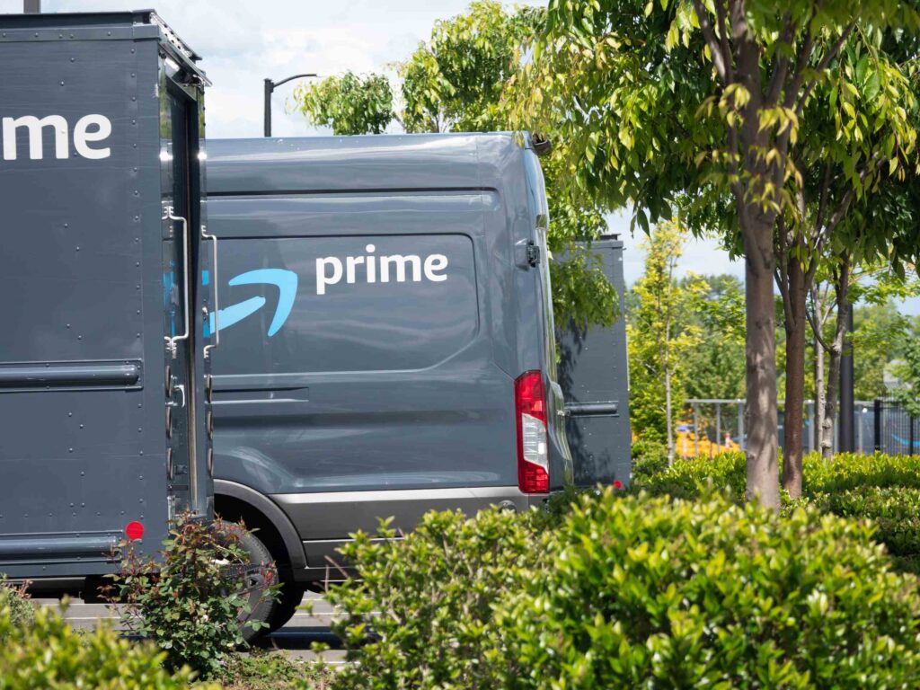 Gray Amazon Prime delivery vans parked in a lot illustrate determining Who's Liable for an Amazon or Delivery Van Accident in Bakersfield.