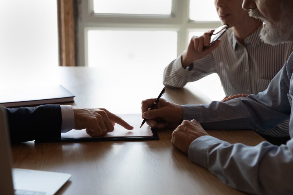 Client signing legal documents during a meeting demonstrating what to expect at your California personal injury deposition.